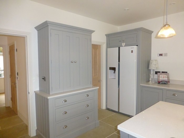 Hand-made painted larder cupboard beside an American fridge freezer in Bloxham