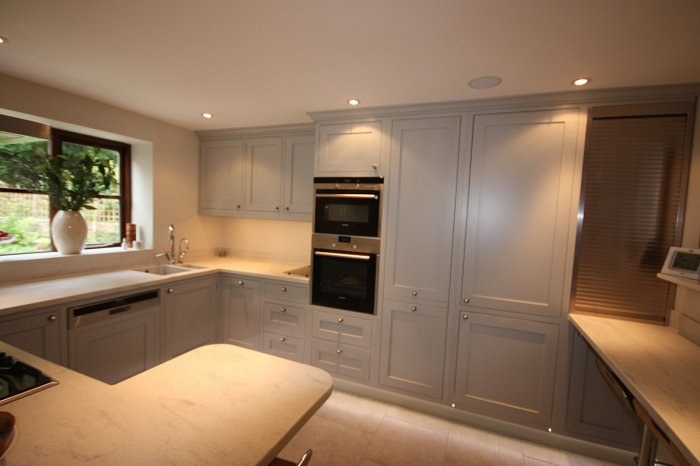 Hand-made painted kitchen with tall larder cabinets and built-in ovens
