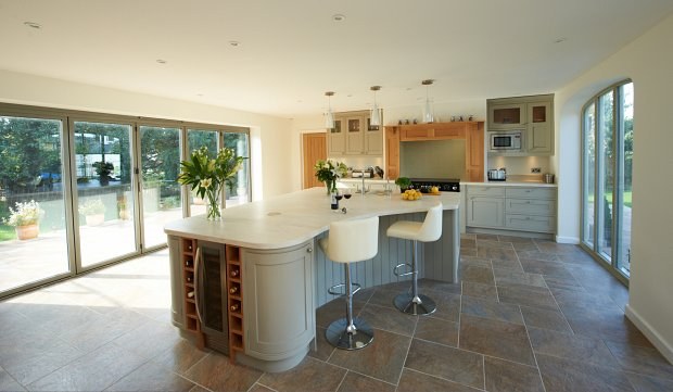The Kings Sutton kitchen island with oak wine racks, seen from the sliding doors