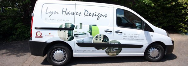 The Lyn Hawes Designs van, white with the script logo and kitchen photographs